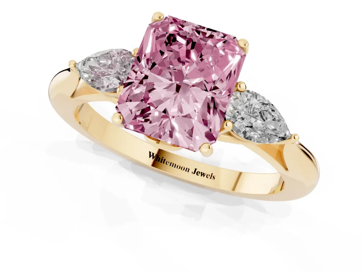 Fancy Pink Three-Stone Radiant Cut Diamond Ring with Pear Side Stones in Four-Prong Setting Yellow gold