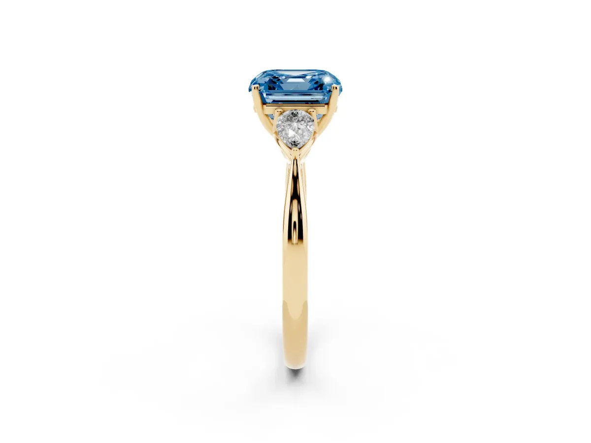 Fancy Blue Three-Stone Asscher Cut Diamond Ring with Pear Side Stones in Four-Prong Setting Yellow gold