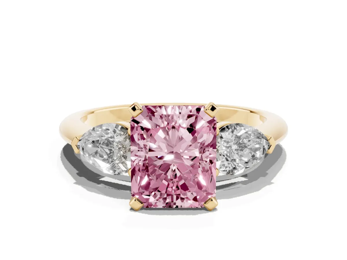 Fancy Pink Three-Stone Radiant Cut Diamond Ring with Pear Side Stones and Four-Prong Setting Yellow gold