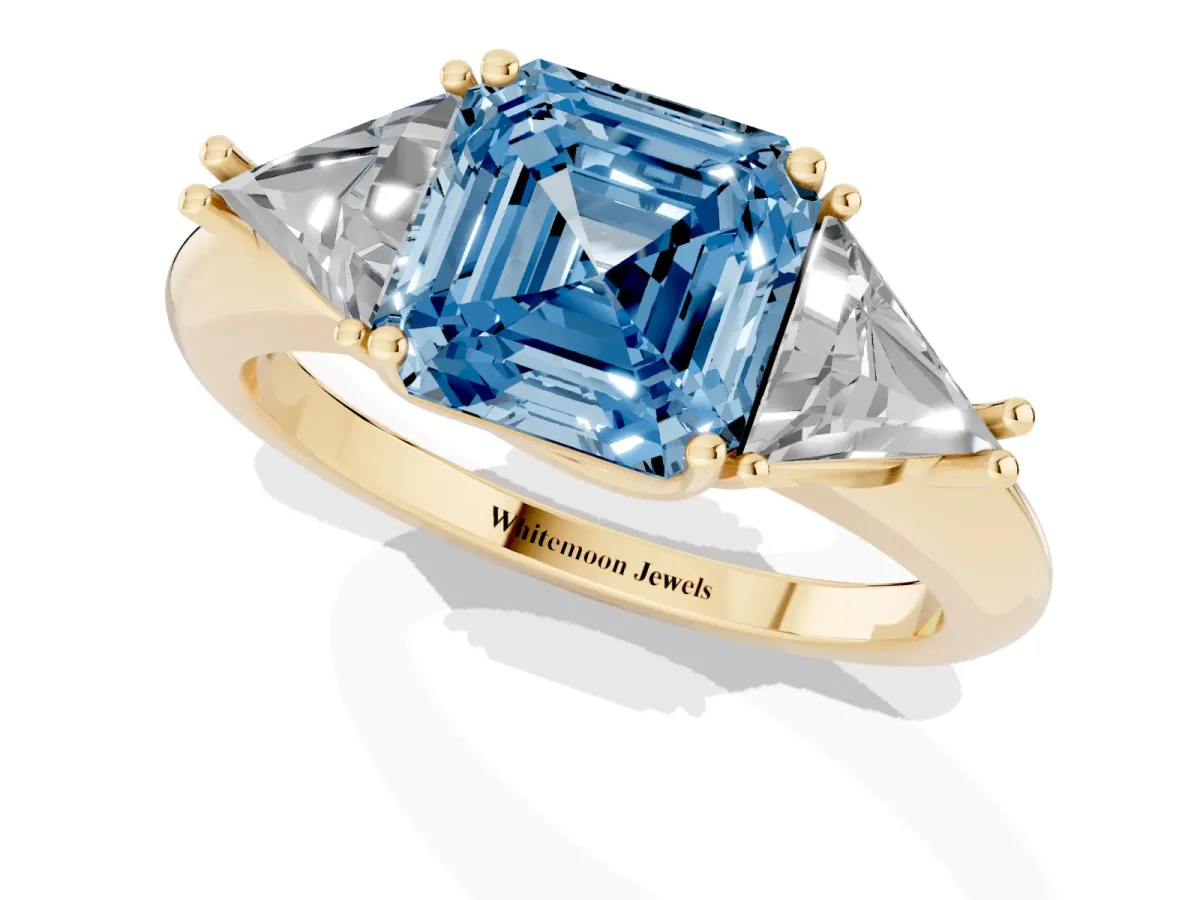 Fancy Blue Three-Stone Asscher Cut Diamond Engagement Ring with Trillion Side Stones and Prong Setting Yellow gold