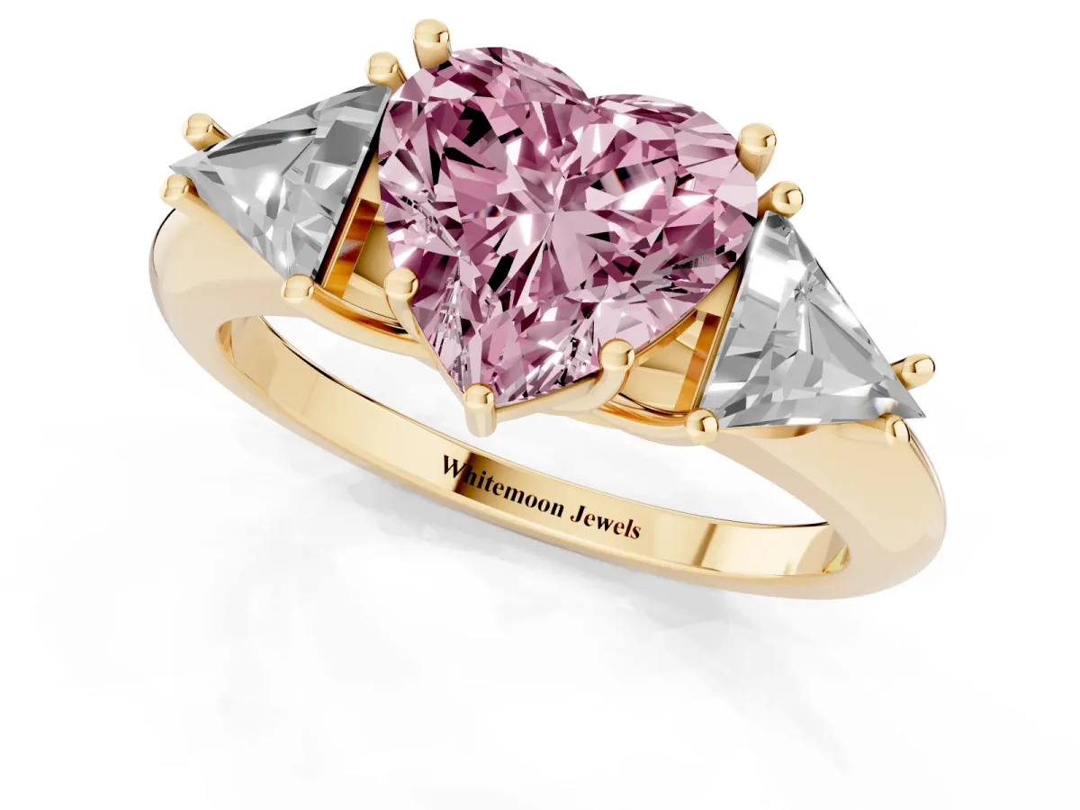 Fancy Pink Three-Stone Heart Cut Diamond Engagement Ring with Trillion Side Stones and Prong Setting Yellow gold