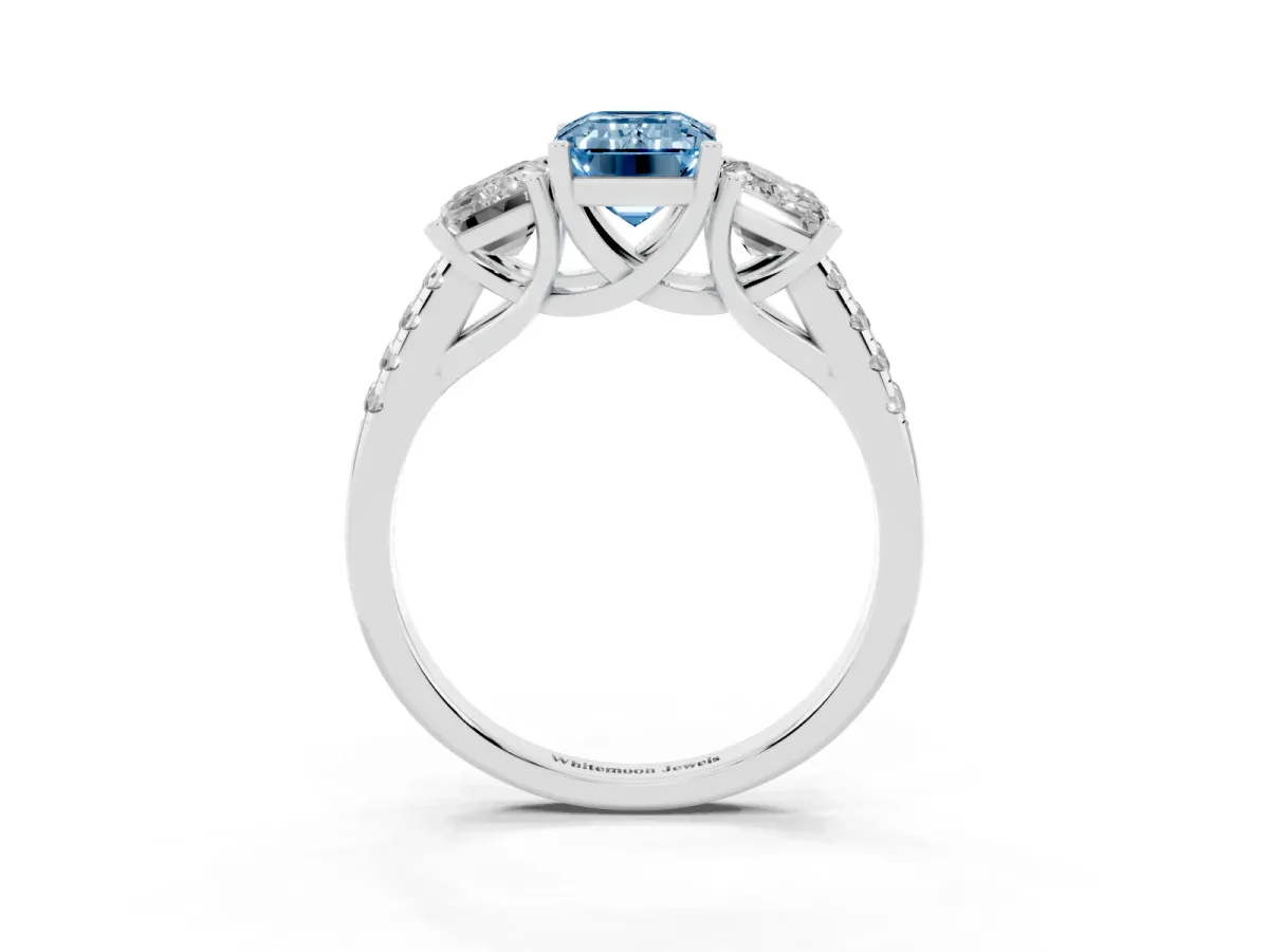Fancy Blue Three-Stone Emerald Cut Diamond Ring with Round Pavé Band and Prong Setting Silver