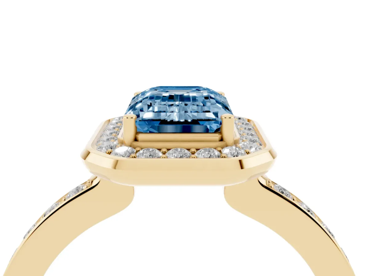 Fancy Blue Emerald Cut Diamond Halo Ring with Bezel Frame and Pavé Band Yellow gold