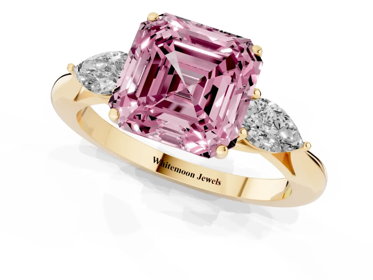 Fancy Pink Three-Stone Asscher Cut Diamond Ring with Pear Side Stones in Four-Prong Setting Yellow gold