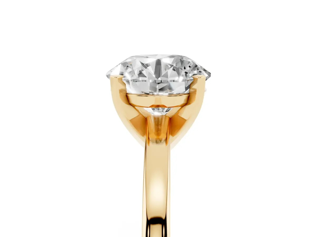 Round Cut Solitaire Diamond Engagement Ring with Four-Prong Setting on a Classic Band Yellow gold