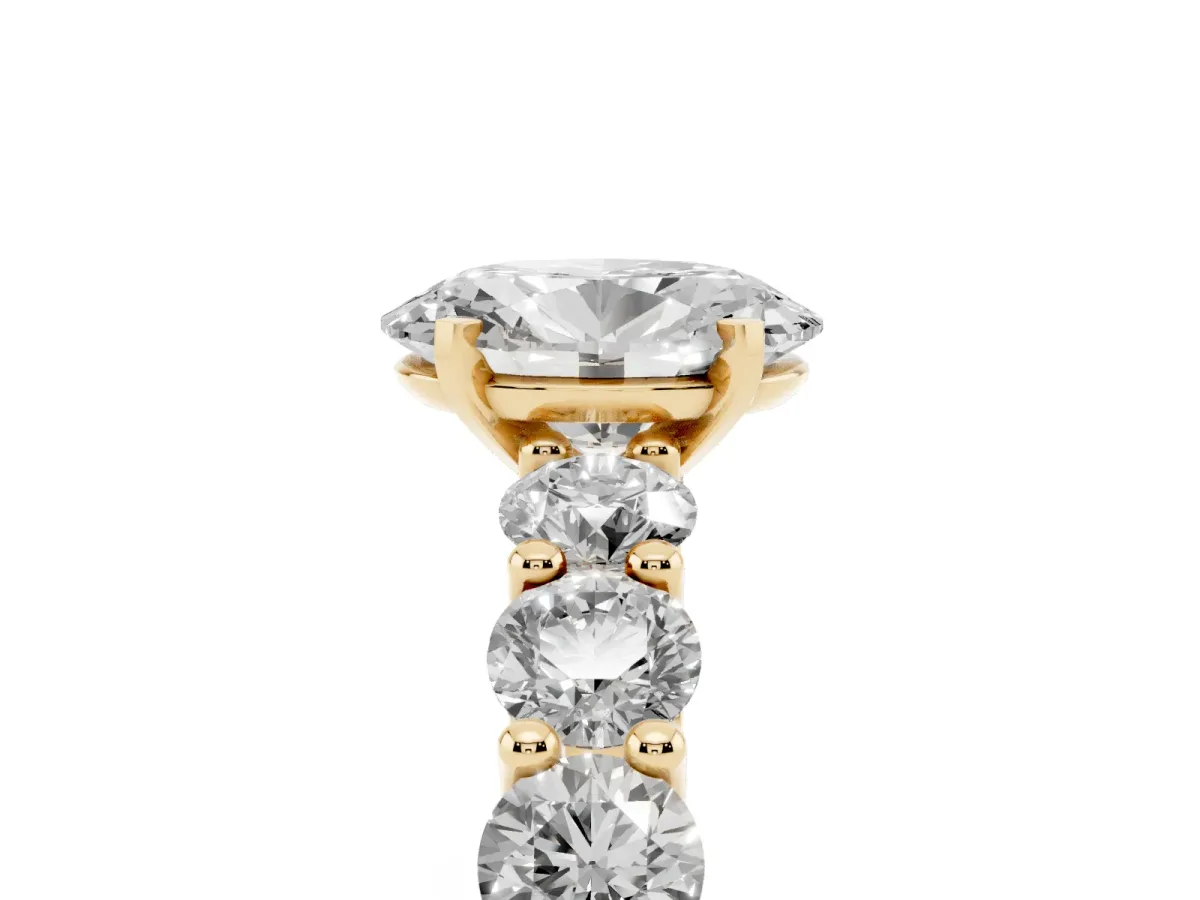 Oval Cut Diamond Prong Setting with Side Stones on a Pave Band Yellow gold