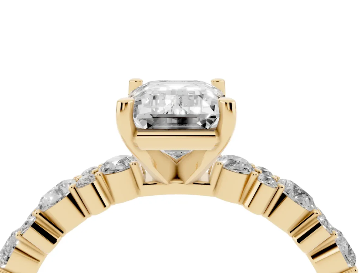 Emerald Cut Diamond Side Stone Solitaire Ring with Round and Four-Prong Setting Yellow gold