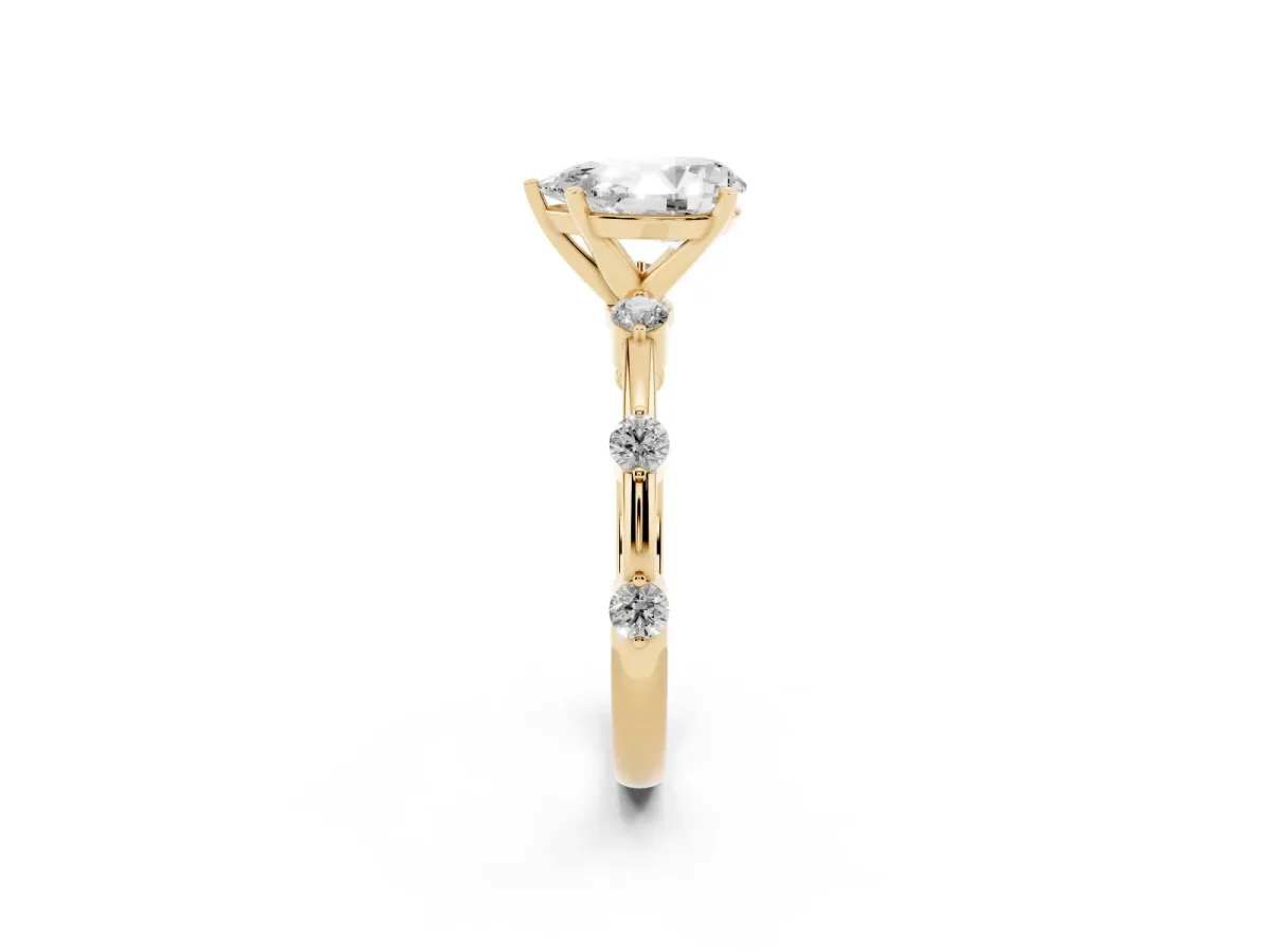 Pear Cut Solitaire Diamond Ring with Bezel Set Side Stones and Prong Setting Yellow gold