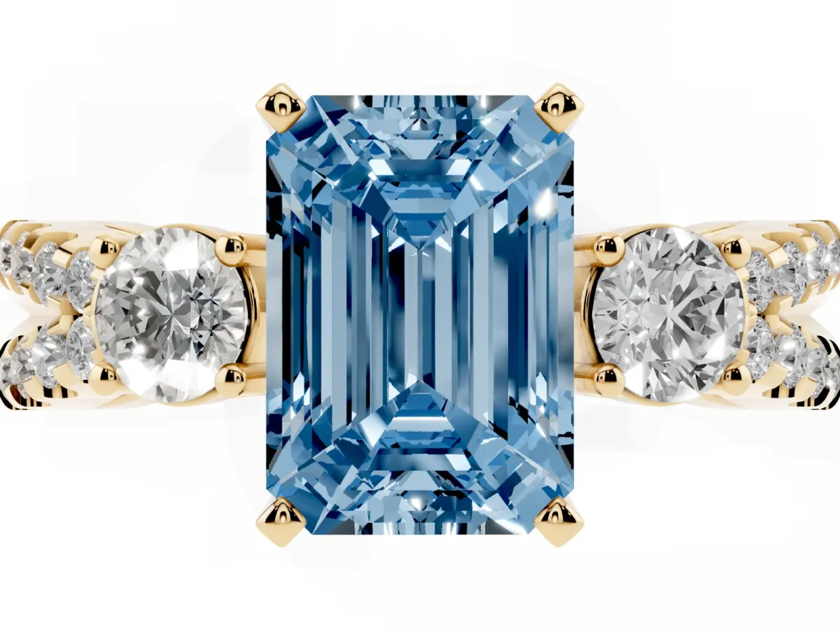 Fancy Blue Emerald Cut Diamond Three-Stone Ring with Pavé Split Shank and Four-Prong Setting Yellow gold