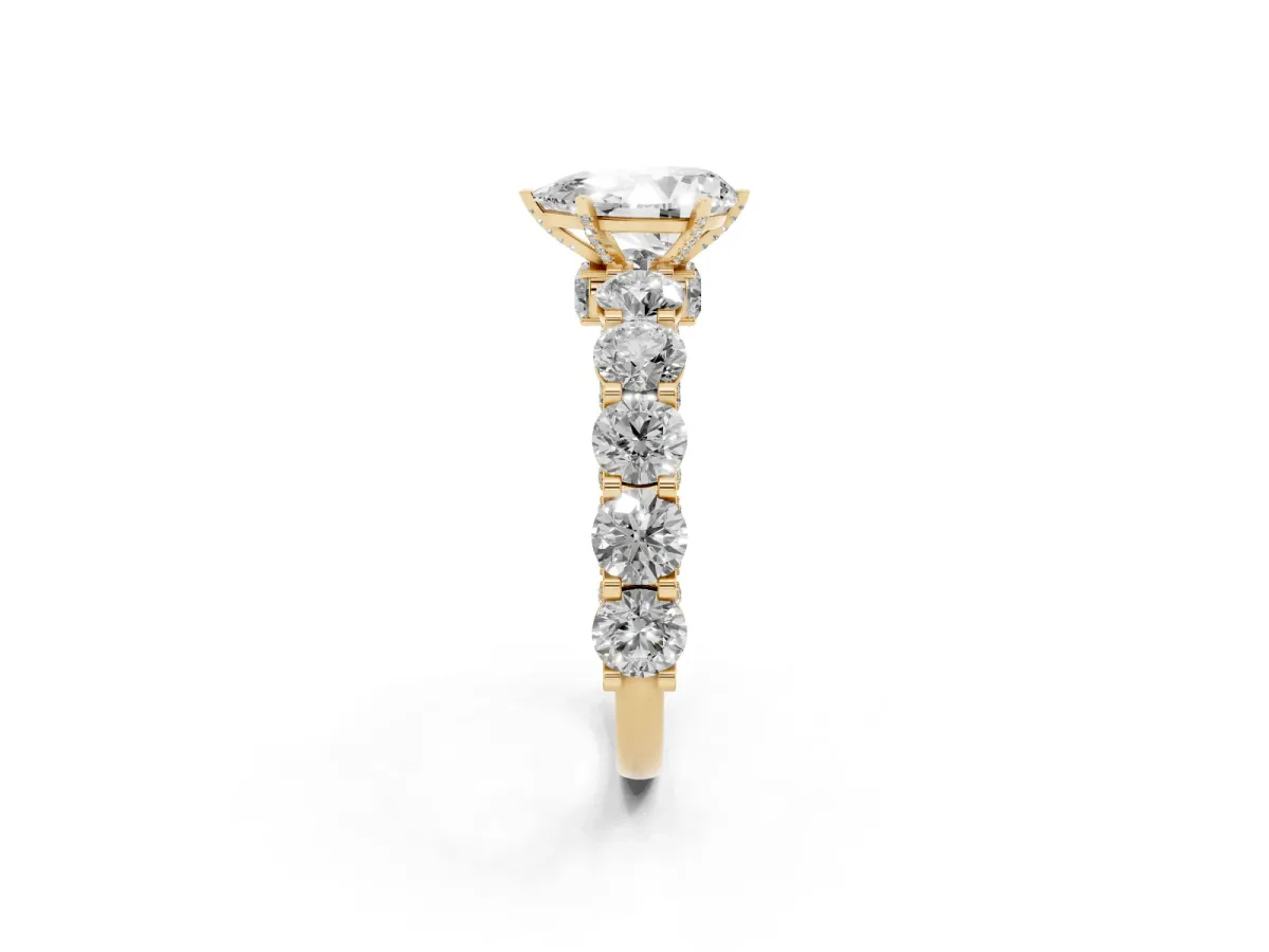 Pear Cut Diamond Side Stone Engagement Ring with Four-Prong Setting Yellow gold