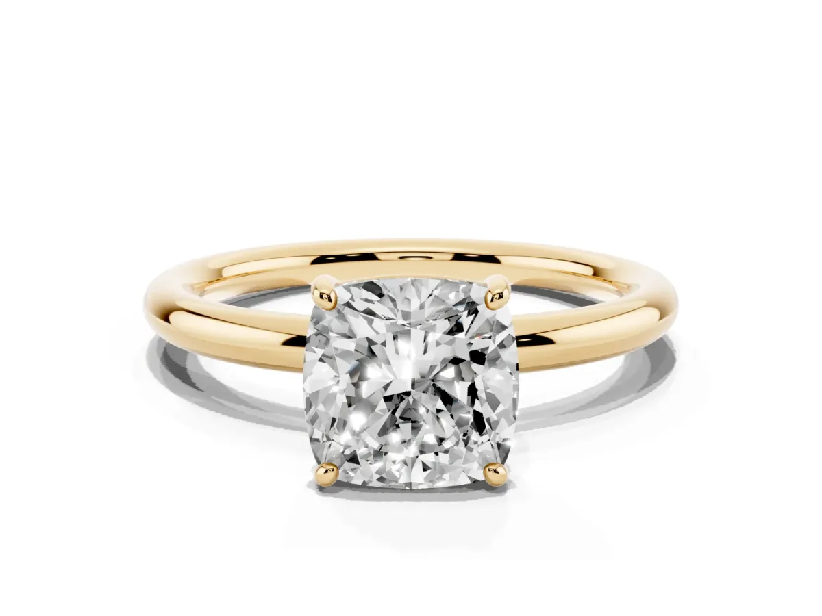 Cushion Cut Solitaire Diamond Ring with Four-Prong Setting on a Plain Band Yellow gold