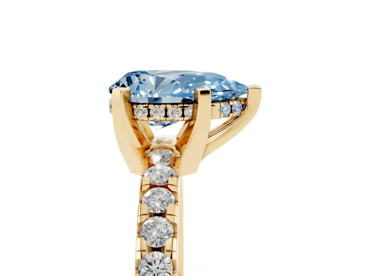 Fancy Blue Pear Cut Diamond Solitaire Ring with Round Pavé Band and Four-Prong Setting Yellow gold