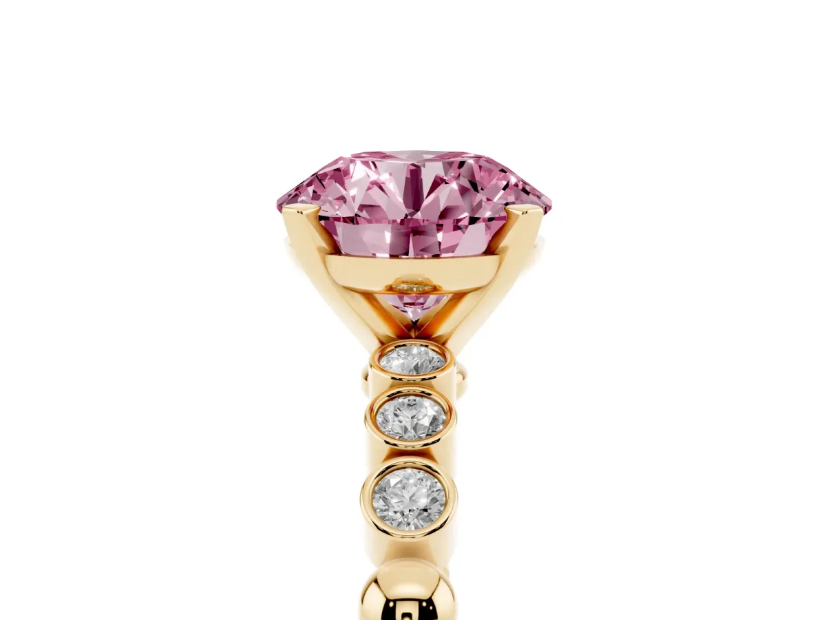 Fancy Pink Round Cut Solitaire Bezel Accent Diamond Engagement Ring with Beaded Band and Four-Prong Setting Yellow gold