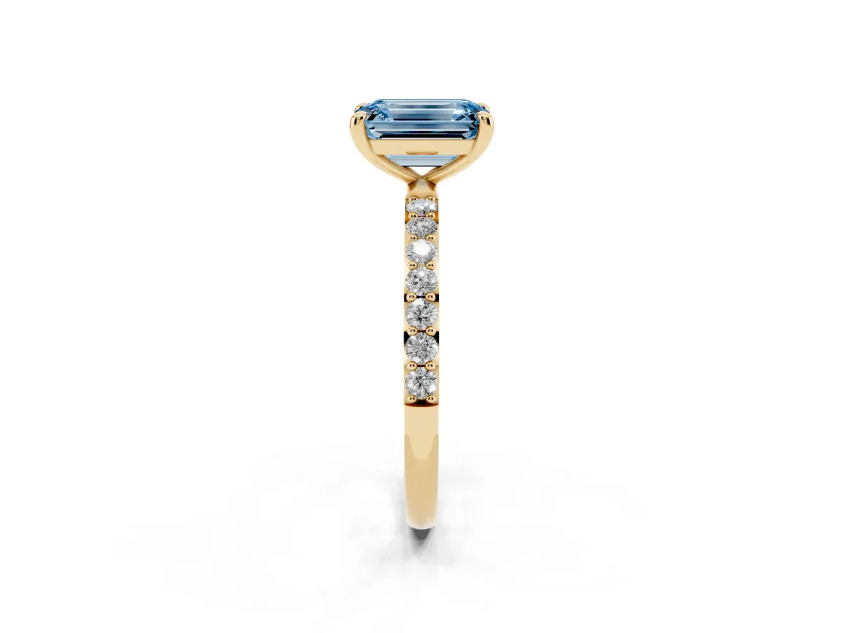 Fancy Blue Emerald Cut Diamond Solitaire Ring with Round Pavé Band and Prong Setting Yellow gold