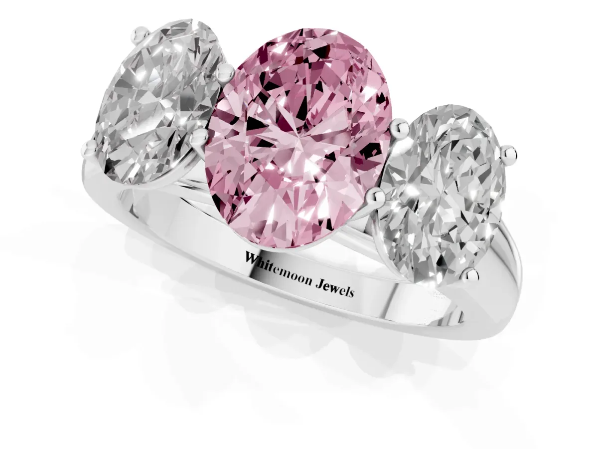 Fancy Pink Oval Cut Three-Stone Diamond Ring with Prong Setting on a Classic Band Platinum