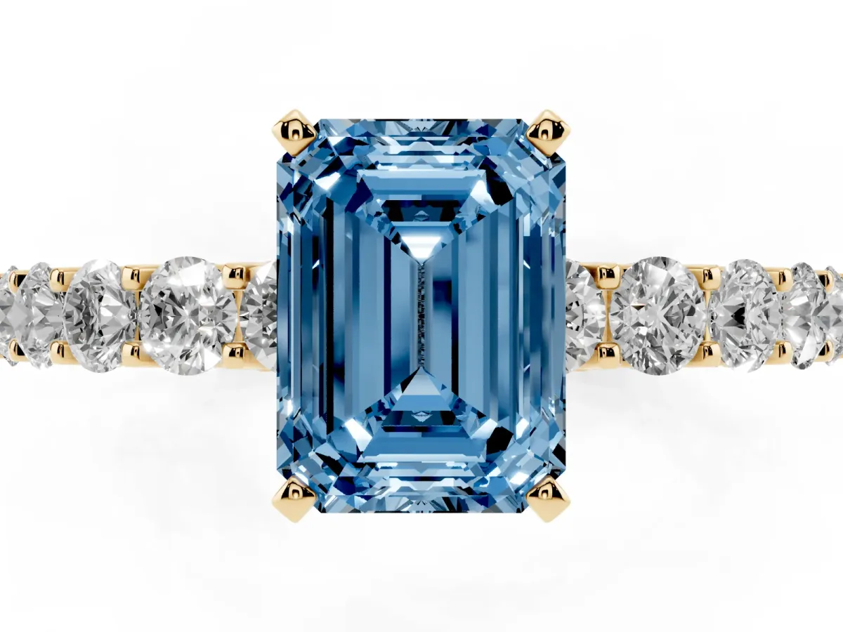 Fancy Blue Emerald Cut Diamond Solitaire Ring with Shared Prong Pavé Band and Four-Prong Setting Yellow gold