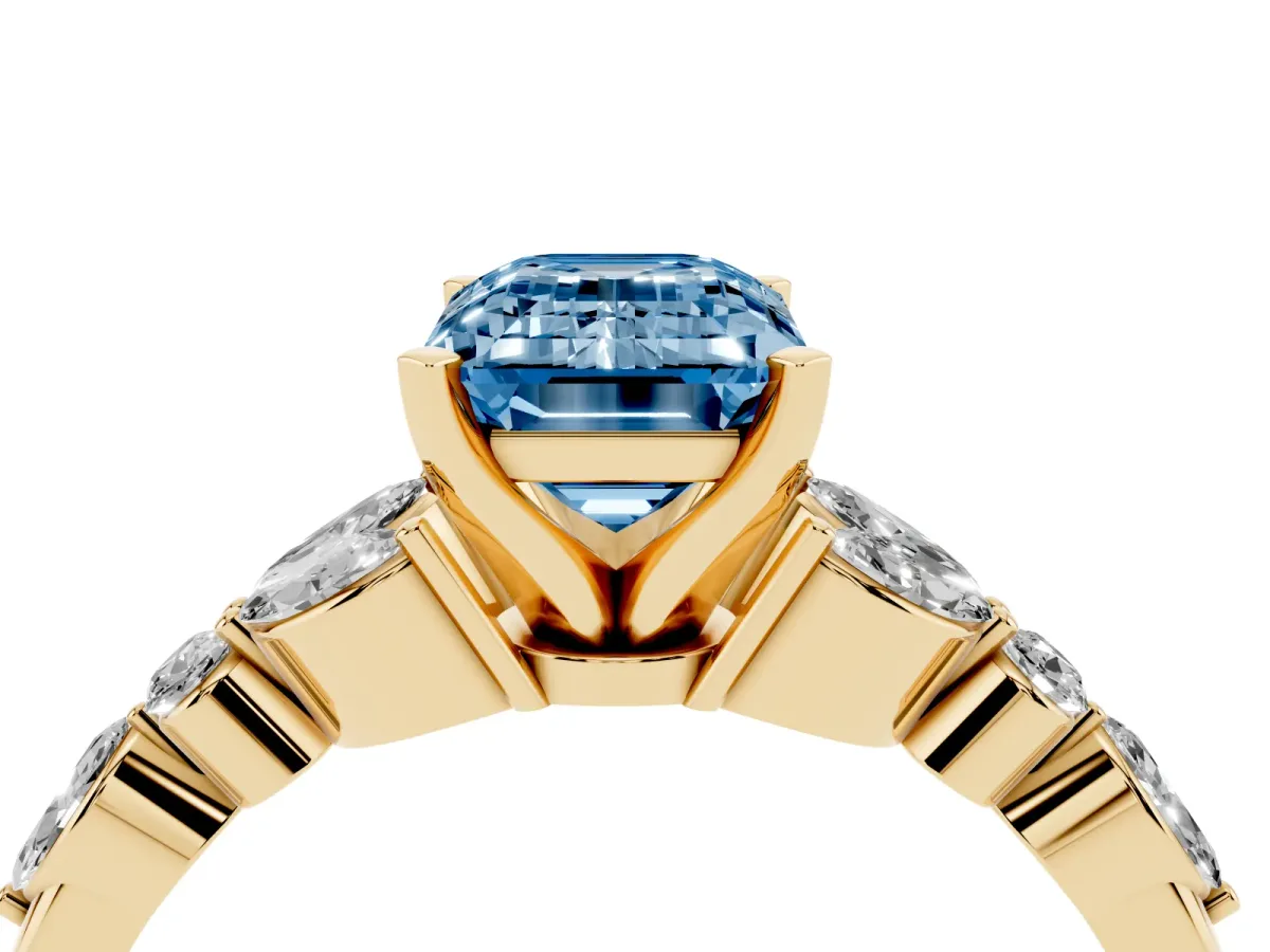 Fancy Blue Emerald Cut Diamond Solitaire Ring with Side Stones and Four-Prong Setting Yellow gold