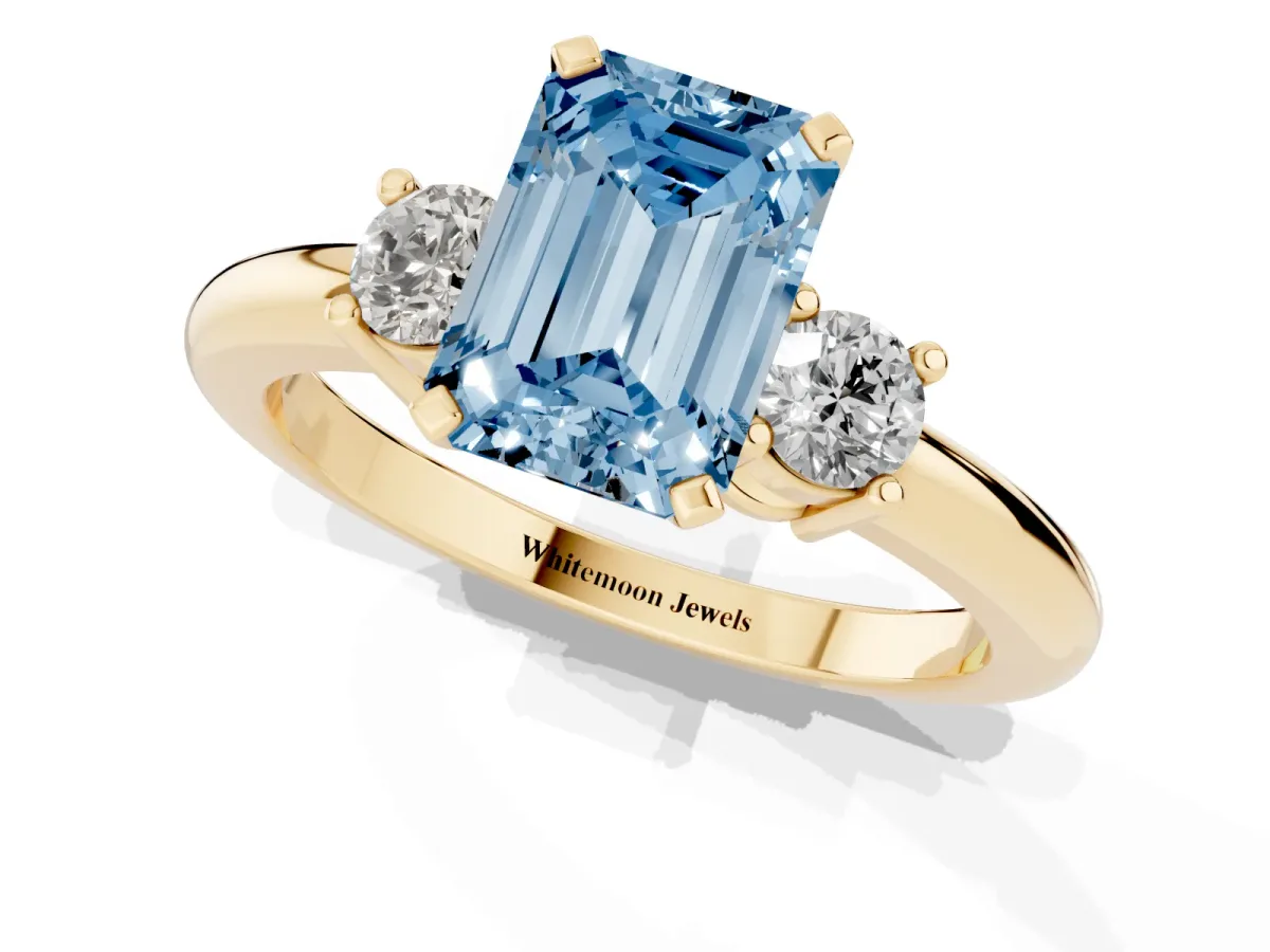 Fancy Blue Three-Stone Emerald Cut Cut Diamond Solitaire with Prong Setting and Classic Band Yellow gold