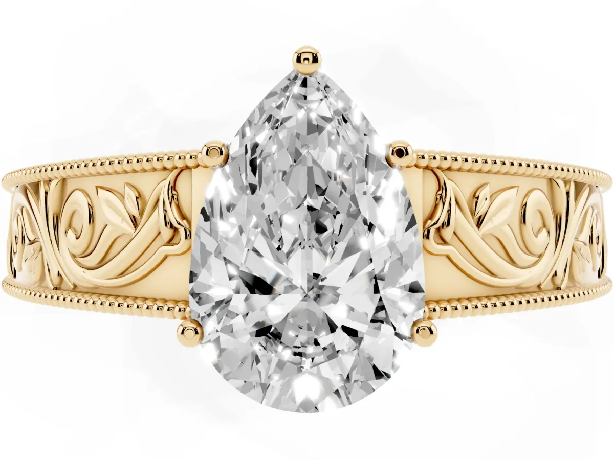 Pear Cut Diamond Solitaire Ring with Engraved Band and Four-Prong Setting Yellow gold