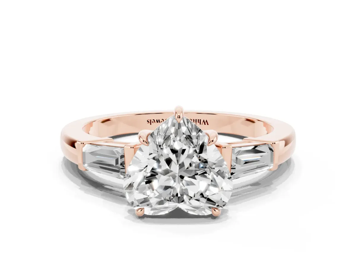 Heart Cut Diamond Three-Stone Ring with Tapered Baguette Side Stones and Prong Setting Rose gold
