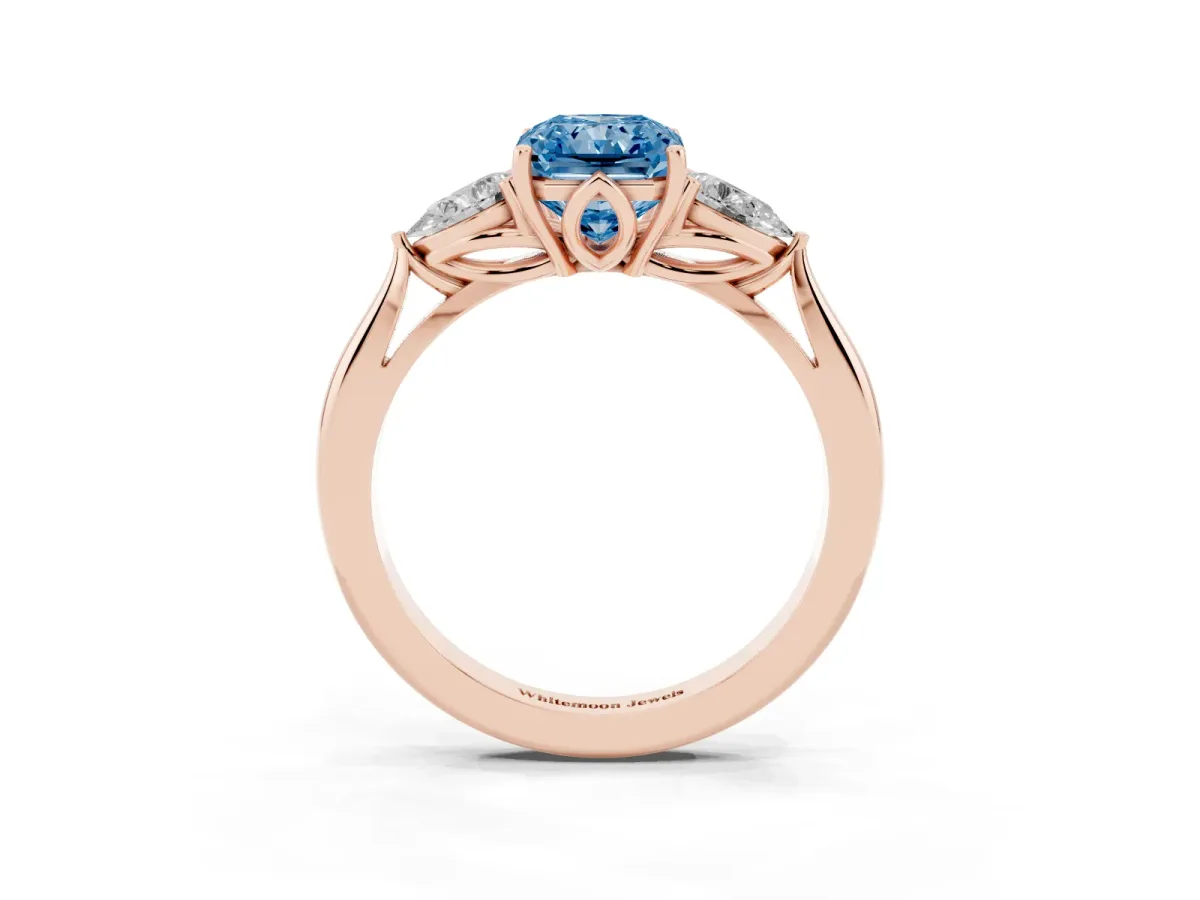 Fancy Blue Three-Stone Radiant Cut Diamond Ring with Pear Side Stones in Four-Prong Setting Rose gold