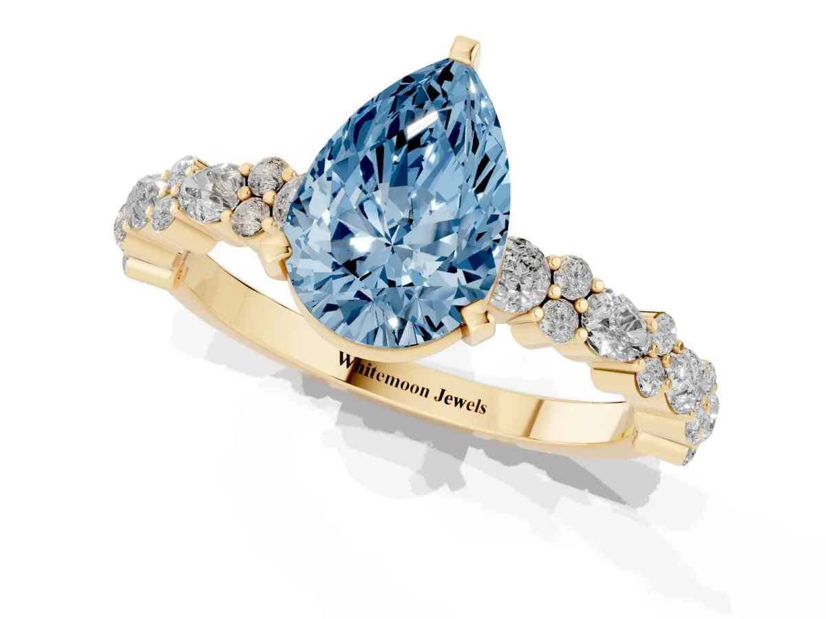 Fancy Blue Pear Cut Diamond Side Stone Solitaire Ring with Round and Four-Prong Setting Yellow gold