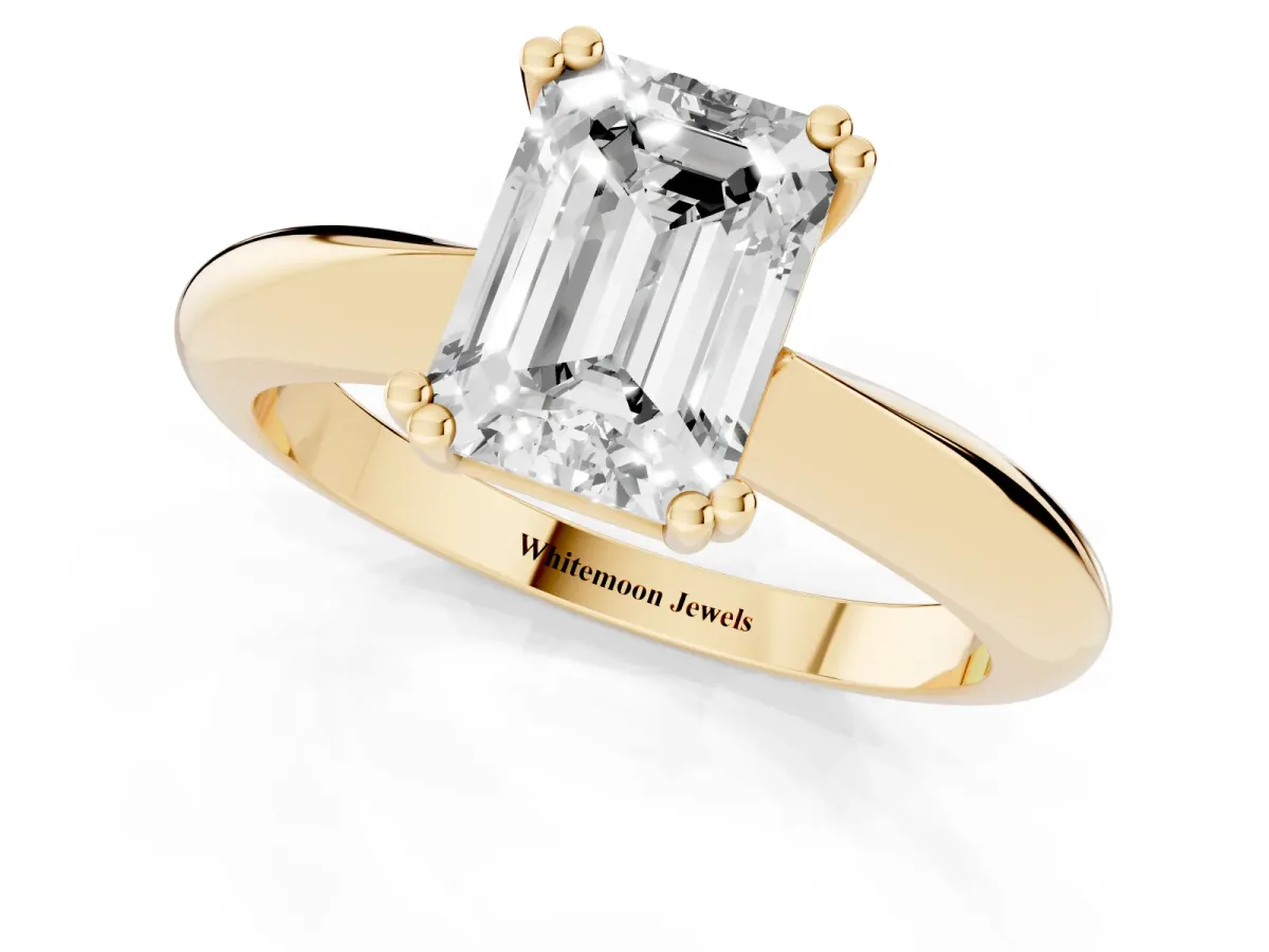 Emerald Cut Cut Solitaire Engagement Ring with Tapered Band and Four-Prong Setting Yellow gold