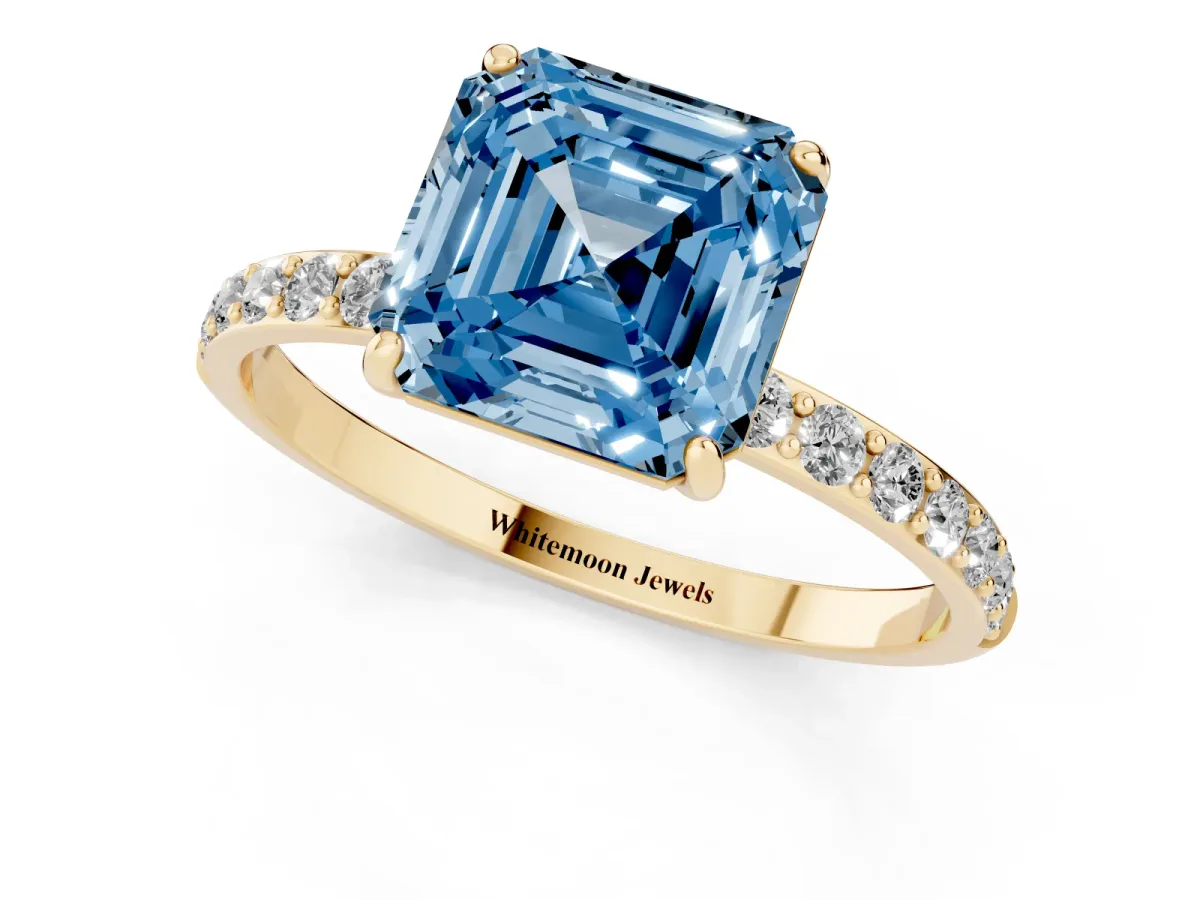 Fancy Blue Asscher Cut Diamond Solitaire Ring with Round Pavé Shoulders and Prong Setting Yellow gold