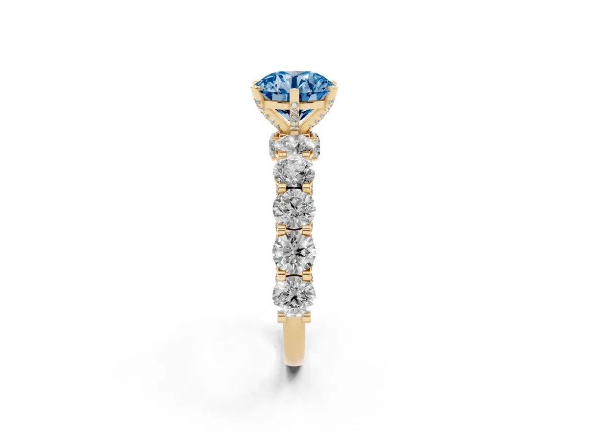 Fancy Blue Round Cut Diamond Side Stone Engagement Ring with Four-Prong Setting Yellow gold