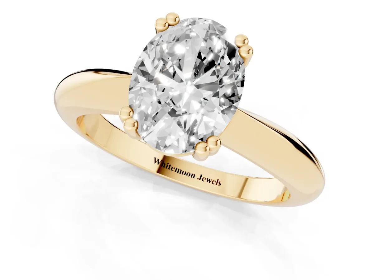 Oval Cut Cut Solitaire Engagement Ring with Tapered Band and Four-Prong Setting Yellow gold