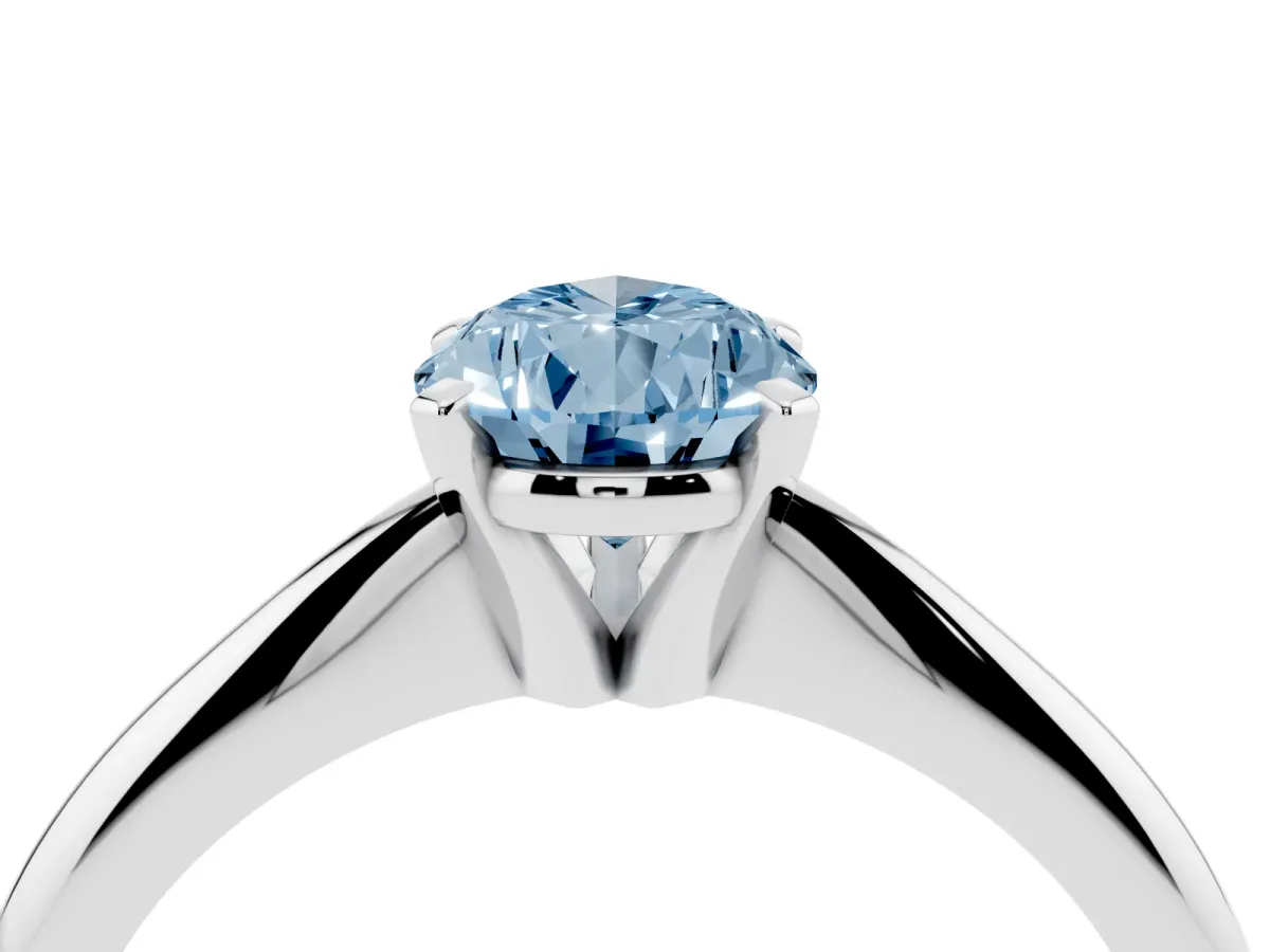 Fancy Blue Pear Cut Cut Solitaire Ring with Four-Prong Setting on a Classic Band Silver