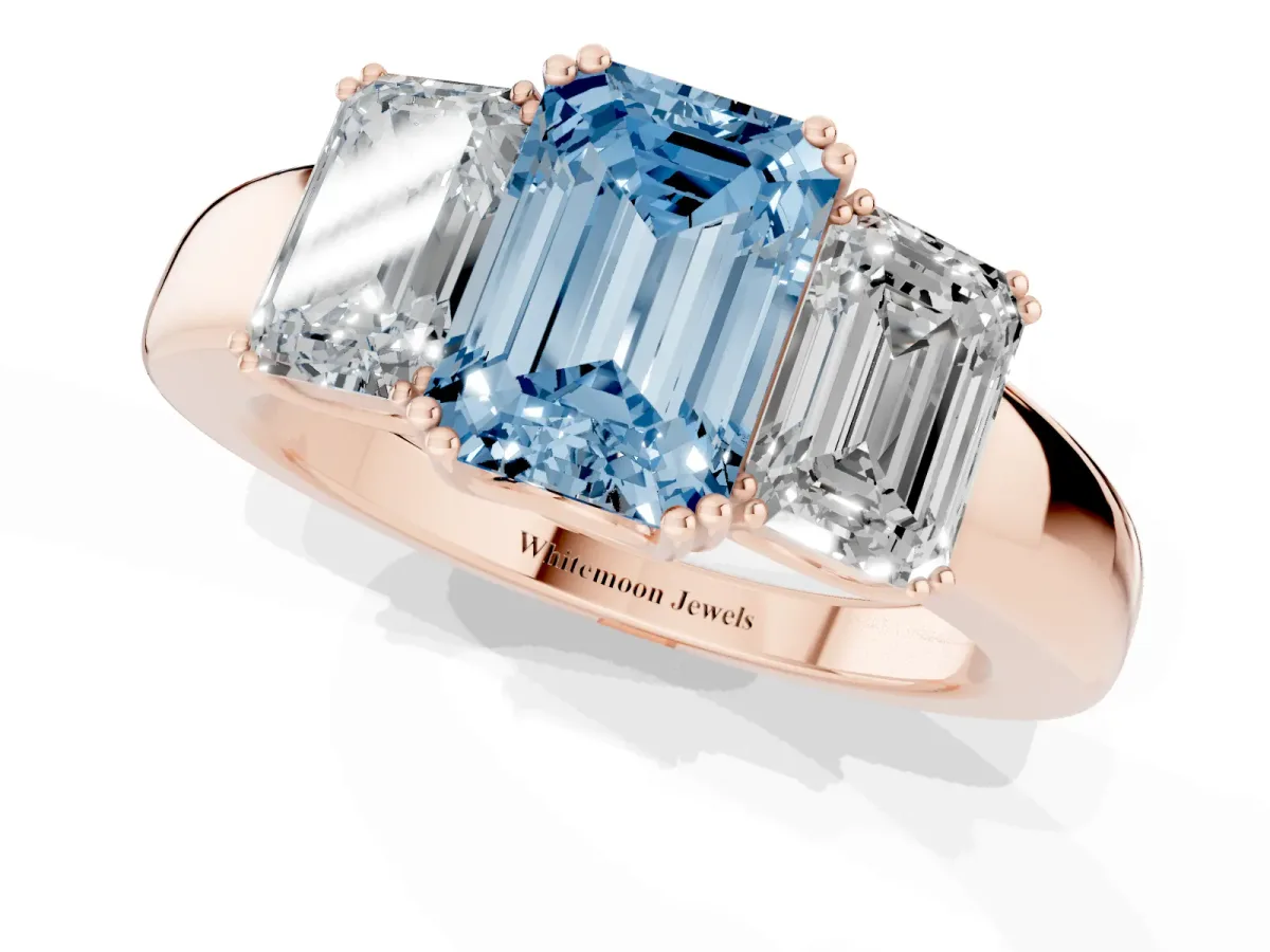 Fancy Blue Three-Stone Emerald Cut Cut Diamond Ring with Channel Set Band and Four-Prong Setting Rose gold