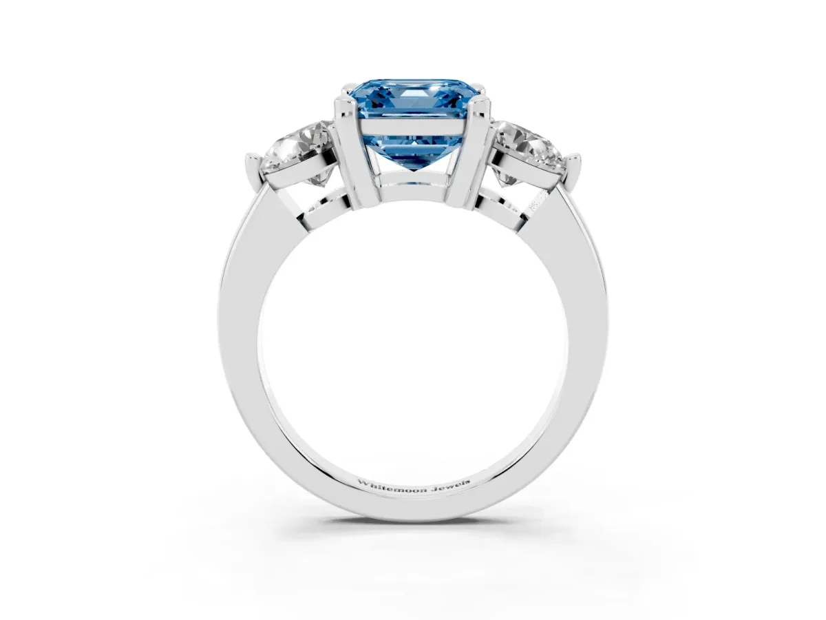 Fancy Blue Three-Stone Asscher Cut Brilliant Cut Solitaire Ring with Prong Setting on a Classic Band Platinum