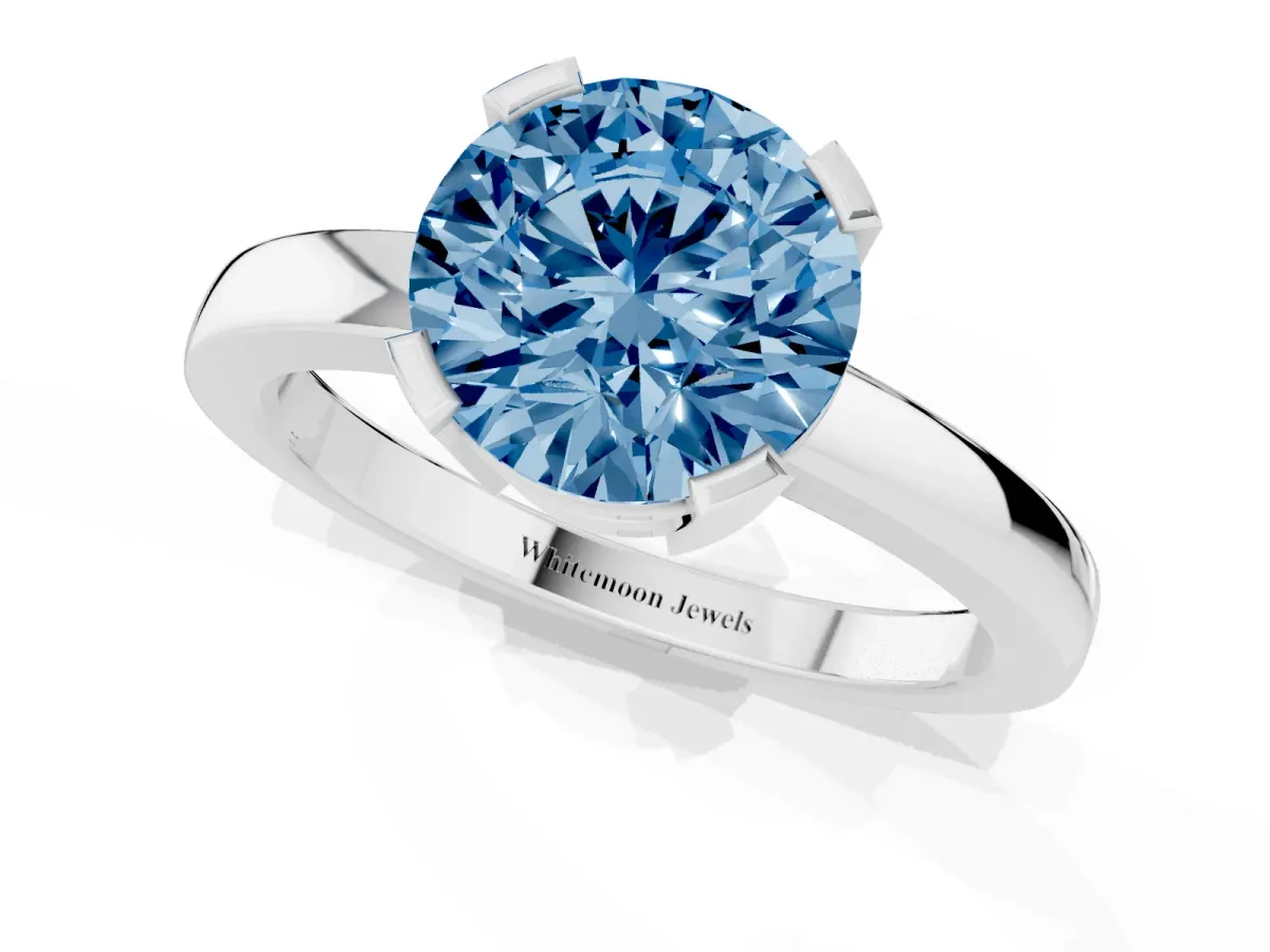 Fancy Blue Round Cut Cut Solitaire Ring with Four-Prong Setting and Classic Band Silver