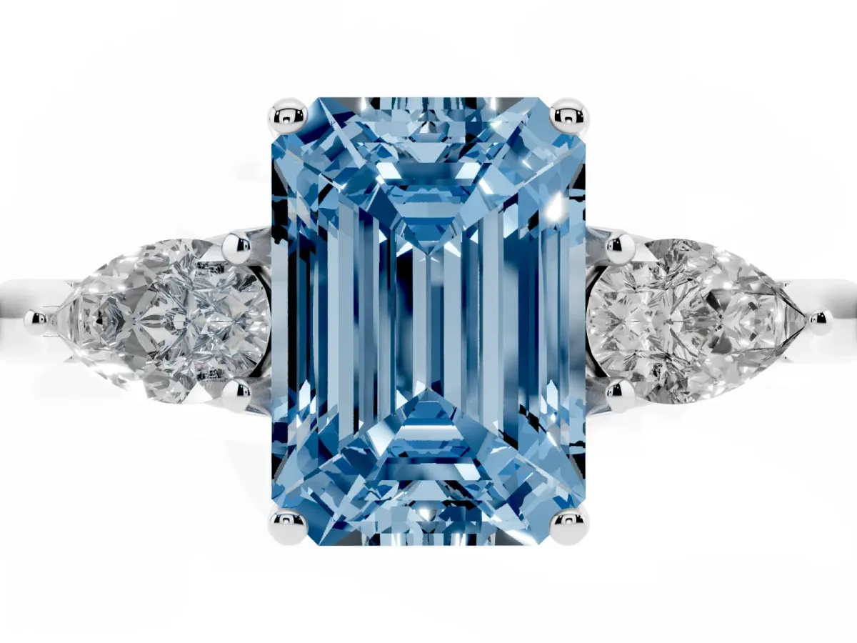 Fancy Blue Emerald Cut Diamond Three-Stone Ring with Pear Side Stones and Prong Setting Platinum