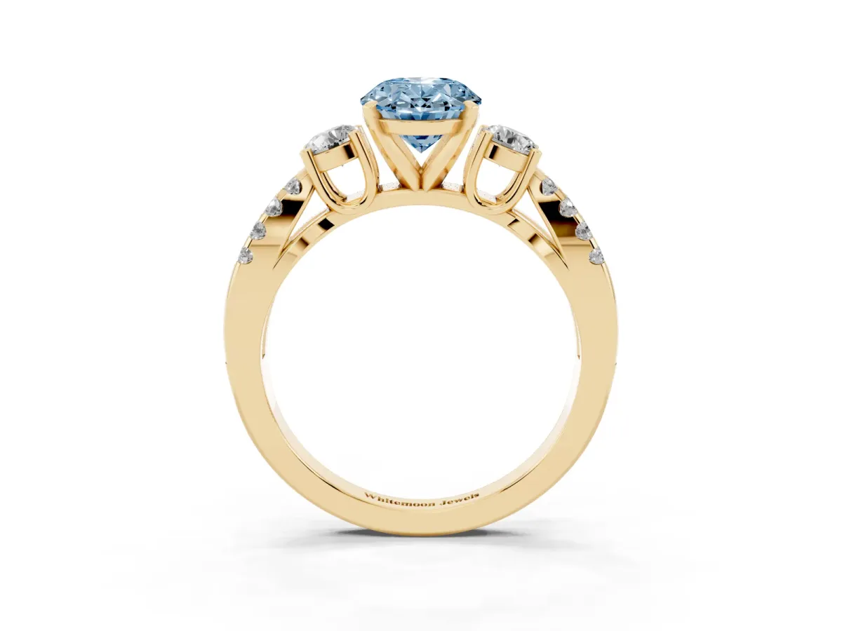 Fancy Blue Oval Cut Diamond Three-Stone Ring with Pavé Split Shank and Four-Prong Setting Yellow gold