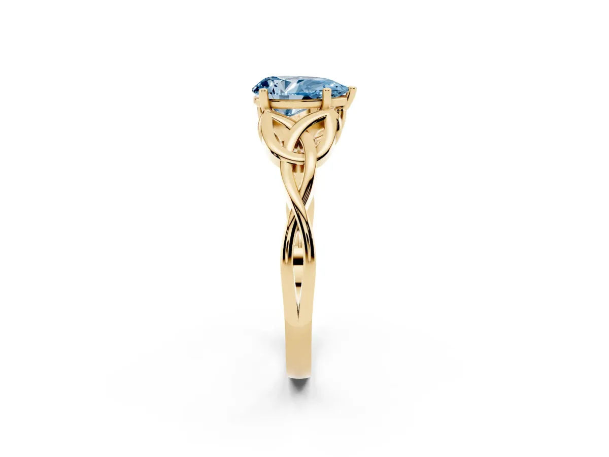 Fancy Blue Pear Cut Diamond Solitaire Engagement Ring with Celtic Knot Band and Four-Prong Setting Yellow gold