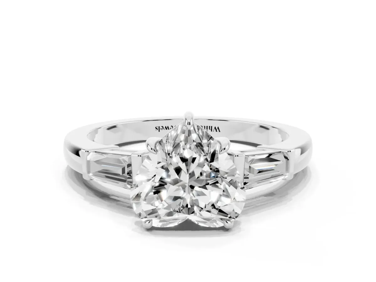 Heart Cut Diamond Three-Stone Ring with Tapered Baguette Side Stones and Prong Setting Platinum