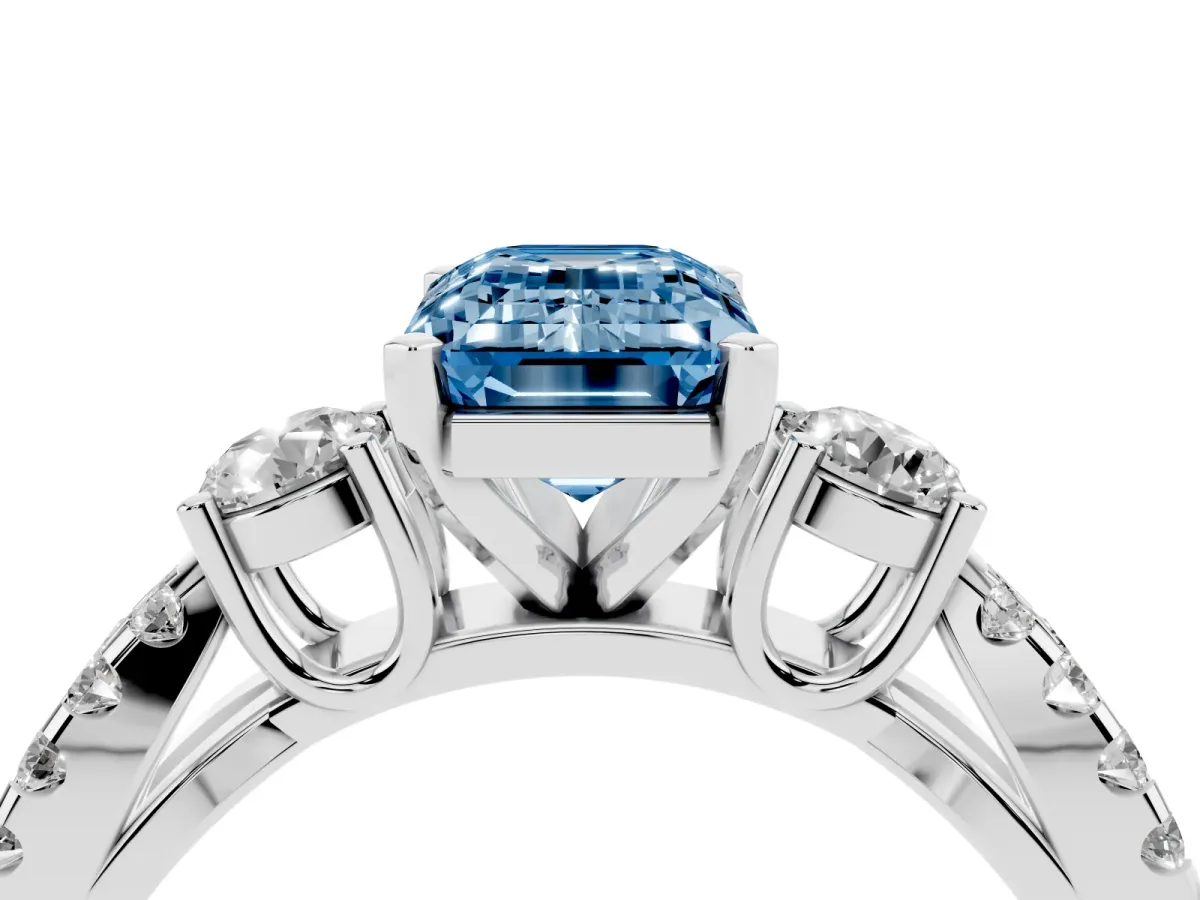 Fancy Blue Emerald Cut Diamond Three-Stone Ring with Pavé Split Shank and Four-Prong Setting Silver