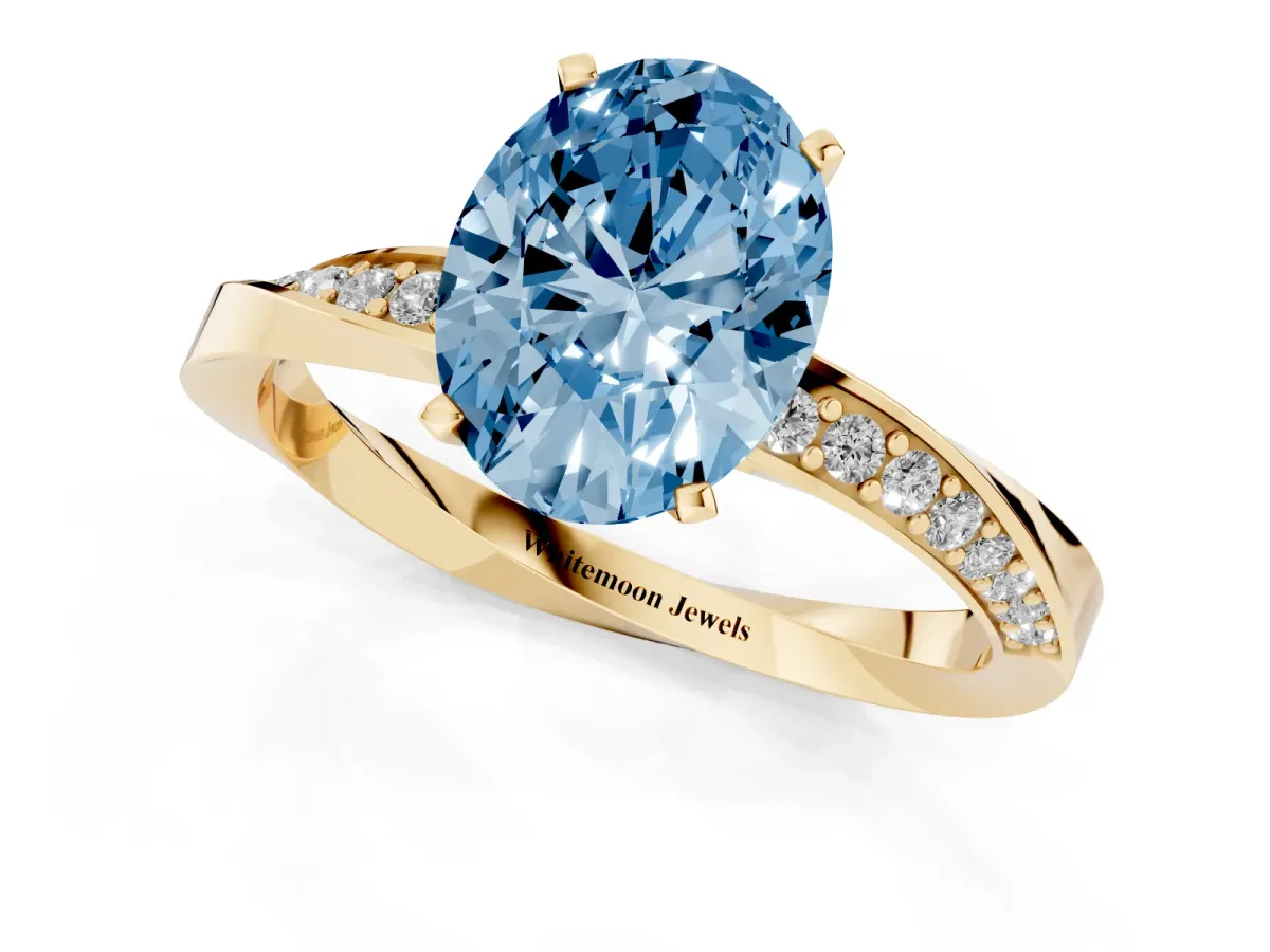 Fancy Blue Oval Cut Diamond Engagement Ring with Side Stone Accents and Four-Prong Setting Yellow gold