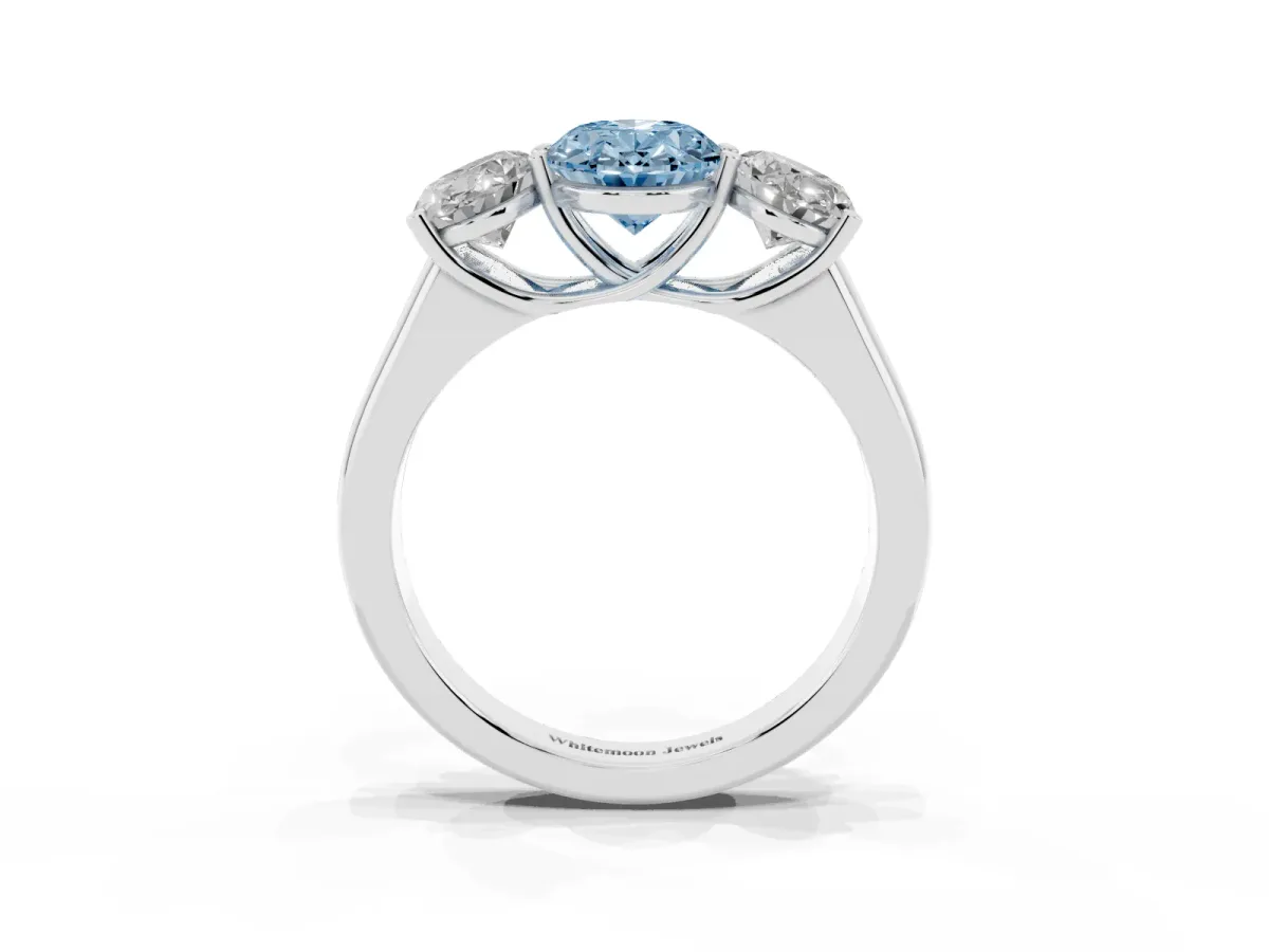 Fancy Blue Oval Cut Three-Stone Diamond Ring with Prong Setting on a Classic Band Platinum
