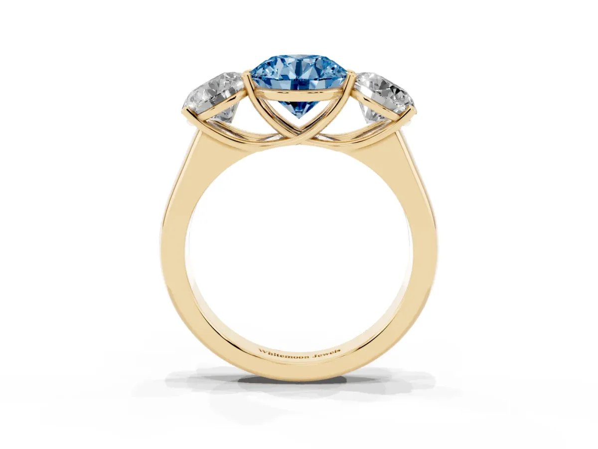 Fancy Blue Round Cut Three-Stone Diamond Ring with Prong Setting on a Classic Band Yellow gold