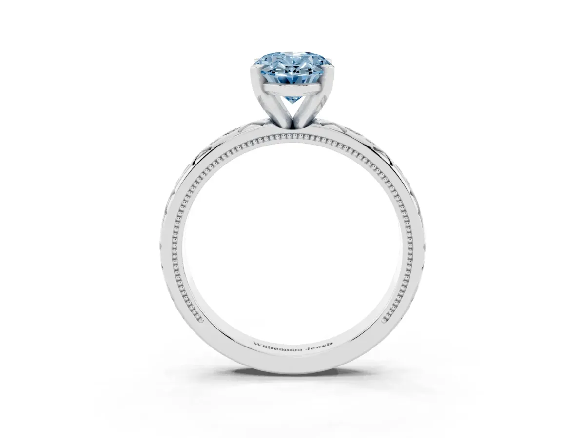 Fancy Blue Oval Cut Solitaire Engagement Ring with Scrollwork Band and Four-Prong Setting Silver