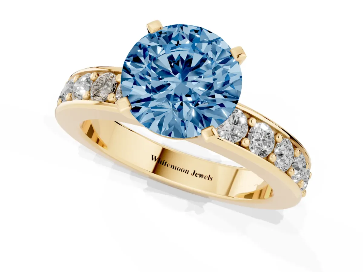 Fancy Blue Round Cut Diamond Engagement Ring with Channel Set Round Band and Prong Setting Yellow gold