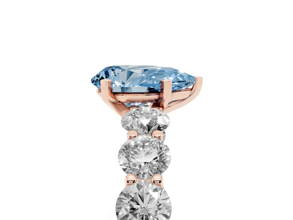 Fancy Blue Pear Cut Diamond Prong Setting with Side Stones on a Pave Band Rose gold