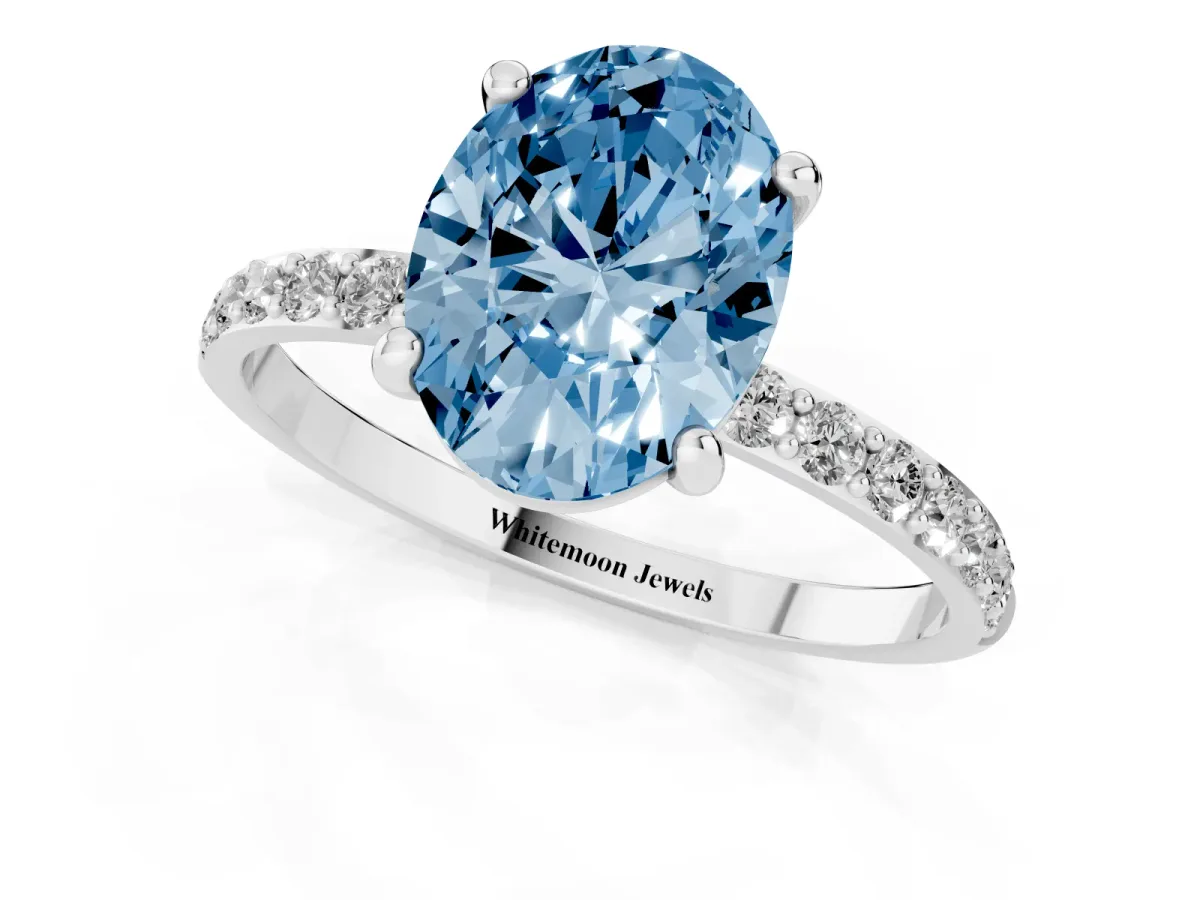 Fancy Blue Oval Cut Diamond Solitaire Ring with Round Pavé Band and Prong Setting Silver