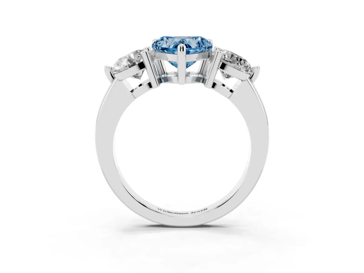 Fancy Blue Three-Stone Heart Cut Brilliant Cut Solitaire Ring with Prong Setting on a Classic Band Silver