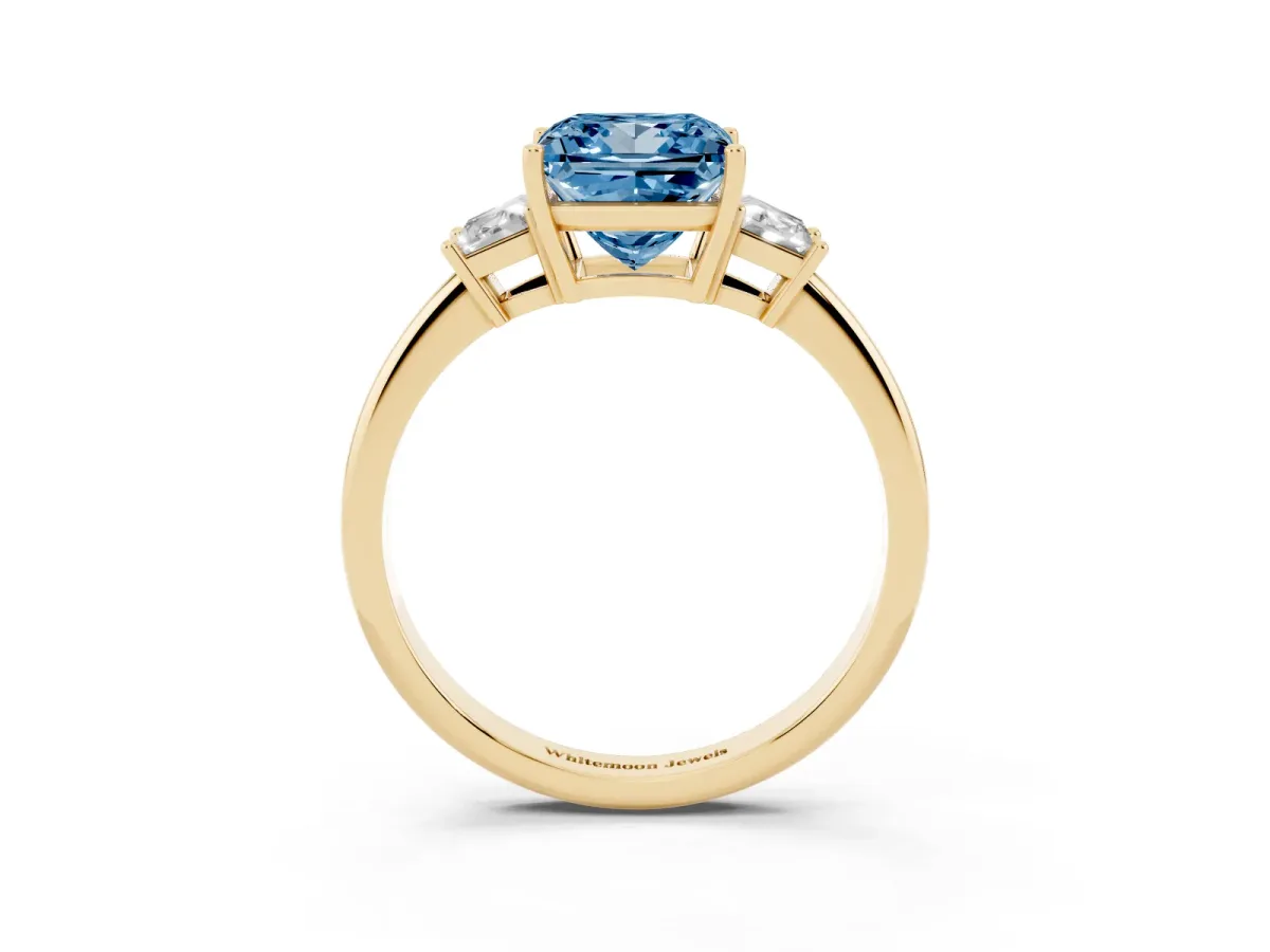 Fancy Blue Princess Cut Diamond Three-Stone Ring with Trapezoid Side Stones and Prong Setting Yellow gold