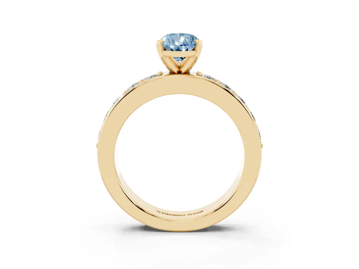 Fancy Blue Pear Cut Diamond Engagement Ring with Channel Set Round Band and Prong Setting Yellow gold