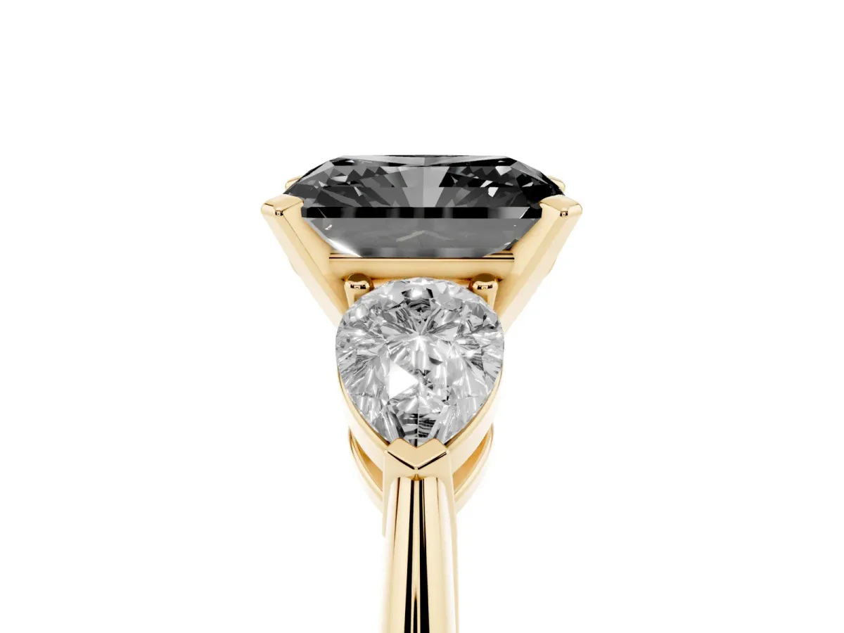 Fancy Black Three-Stone Radiant Cut Diamond Ring with Pear Side Stones and Four-Prong Setting Yellow gold